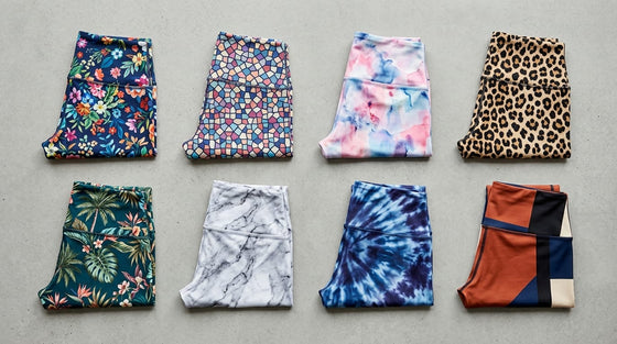 Flat-lay grid of eight printed activewear leggings showcasing different patterns: floral, mosaic, watercolor, leopard, tropical, marble, tie-dye, and color-block