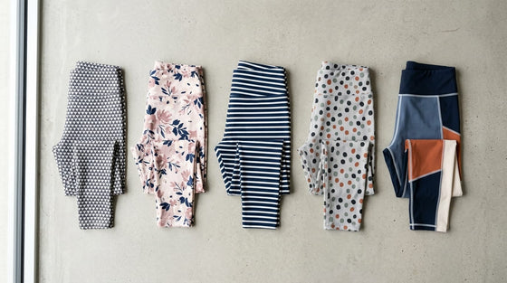 Flat-lay of five affordable patterned activewear leggings on a concrete-gray surface