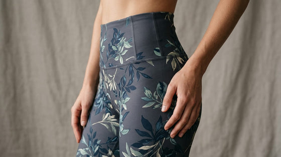 Close-up of a high-waisted floral-pattern legging showing the wide reinforced waistband detail