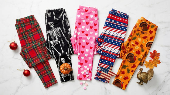 Collection of holiday leggings in Christmas tartan, Halloween skeleton, Valentine's Day hearts, patriotic stars and stripes, and Thanksgiving harvest prints