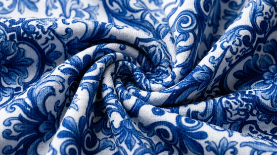 Macro view of FIERCEPULSE Blue Majolica printed legging fabric showing the cobalt tile print inside the stretch knit